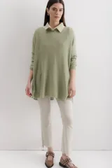 Sweater color crema de viscosa, poliéster, elastano y lurex, de corte holgado y mangas largas.