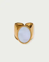 Anillo dorado con una piedra redonda de nácar.