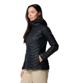 Chaqueta híbrida para mujer, color negro, con cuerpo acolchado con aislamiento Thermarator y paneles laterales softshell elásticos. Presenta cuello alto con protección de barbilla, capucha con ribete y cierre frontal con cremallera.