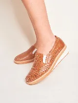 Panchita de cuero color beige con diseño calado, suela blanca y elástico en los laterales.