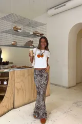 Remera blanca de algodón con estampado de dos naranjas con hojas verdes.