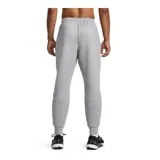 Pantalón de jogging gris de corte ajustado, con cintura elástica ajustable con cordón, bolsillos laterales con cierre y logo de Nike bordado en negro en la pierna izquierda.