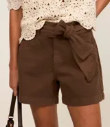 Short corto color marrón, de tiro medio, con cinturón de la misma tela y bolsillos laterales.