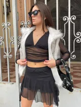 Minifalda negra con volados y transparencias.