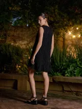 Vestido corto azul marino con lurex, corte recto, sin mangas y volado en el ruedo.