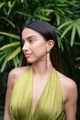 Aros colgantes dorados con forma de abanico y flecos de mostacillas color salmón.