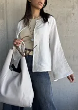 Chaqueta blanca de bambula con bordados en el cuello, mangas y frente.