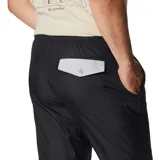 Pantalón deportivo negro de corte ajustado, con cintura elástica ajustable, bolsillos laterales con cierre y puños elásticos.