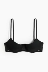 Soutien push-up negro de malla con diseño de lunares. Modelo de media copa y corte bajo con breteles ajustables, copas acolchadas con aros y cierre de corchetes en la espalda.