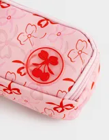 Cartuchera rosa claro con estampado de moños rojos y logo de cerezas. Tiene tres divisiones internas con cierre y tiracierre de moñitos.