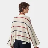 Sweater tejido color crudo con rayas horizontales rojas y azules, de corte holgado y mangas 3/4.