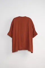 Blusa blanca de corte holgado, con escote en V y mangas 3/4.
