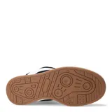 Zapatillas deportivas negras con detalles en blanco, suela blanca y base marrón.