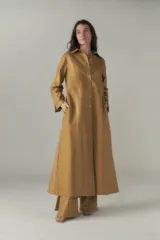 Vestido camisero largo color ocre, con cuello camisero, abotonadura frontal y mangas largas con presillas.