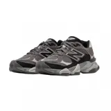 Championes urbanos New Balance modelo 9060, color gris con detalles en negro y blanco, confeccionados en gamuza y malla, con logo "N" característico en los laterales y entresuela con amortiguación.