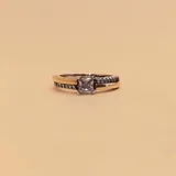 Anillo de plata 925 y oro con una circonia central cuadrada y circonias pequeñas en los laterales.