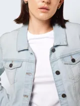 Chaqueta de jean celeste de corte clásico con cuello, cierre frontal con botones, bolsillos delanteros y mangas largas.