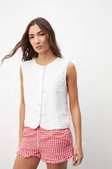 Chaleco blanco con botones al frente y sin mangas.