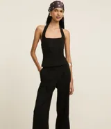 Pantalón wide leg negro de crepé, con cintura alta, pliegues, botón y trabillas.