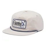 Gorra unisex de 5 paneles color beige con logo de Columbia Sportswear Company con un pez bordado en el frente. Tiene visera plana, cierre trasero ajustable y cuerda decorativa azul en la base de la gorra.