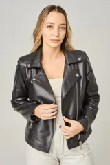 Campera estilo motociclista de cuero color marrón caramelo, con cuello solapa, cierre asimétrico plateado y detalles de broches metálicos.