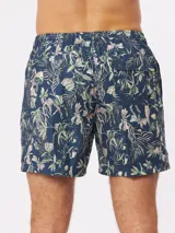 Short de baño azul marino con estampado de hojas, flores y texto en tonos pastel.