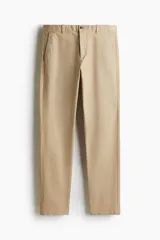 Pantalón chino color beige, de corte slim fit, con bolsillos laterales y traseros.