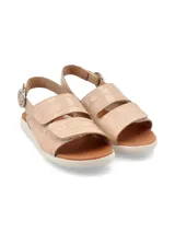 Sandalia color beige con capellada de cuero, suela blanca y ajuste con hebilla.