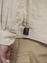 Camisa celeste a cuadros blancos, de manga larga y corte recto.