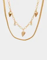 Collar corto de doble cadena dorada con dijes de corazón y strass.