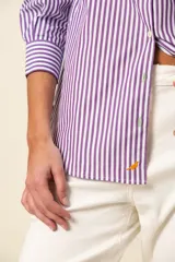 Camisa de manga larga a rayas verticales color violeta y blanco, con cuello clásico y corte recto.