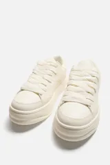 Zapatillas negras con estampado animal, de cordones y suela gruesa.