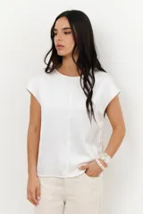 Blusa de manga 3/4 y cuello redondo, confeccionada en lino con acabado metalizado en tono beige o dorado claro.