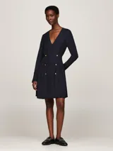 Vestido corto azul marino de viscosa, con escote en V, mangas largas y cierre cruzado con doble botonadura dorada.
