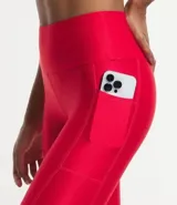 Calza legging deportiva roja de poliamida y elastano, con cintura alta, recortes y bolsillo lateral.