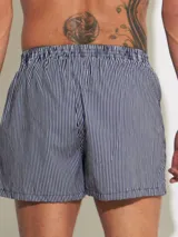 Bóxer de algodón blanco con estampado de flores pequeñas color celeste, con cintura elástica y logo de la marca en el centro.