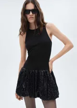 Minivestido negro con cuerpo ajustado sin mangas y falda globo cubierta de lentejuelas.