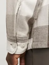 Sobrecamisa a cuadros grandes color marrón, beige y blanco, de manga larga, con cierre de botones y dos bolsillos con botón en el pecho.
