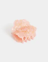 Broche para el pelo color rosa claro con forma de flor y detalles dorados.