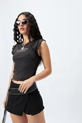 Remera negra con estampa frontal de la palabra 'Fearless' en color blanco. Corte ajustado y terminaciones con volados sutiles.