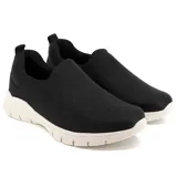Championes negros de Usaflex, estilo slip-on, con capellada de tejido elástico y suela chunky blanca.