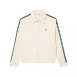 Campera deportiva Lacoste color crema con cierre frontal, cuello americano y bolsillos laterales. Presenta dos líneas verdes a lo largo de las mangas y logo de la marca bordado en el pecho.