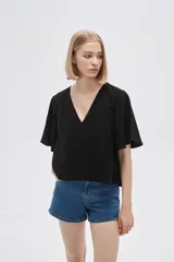 Blusa negra de viscosa, corte holgado y escote en V.