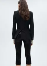 Calza capri negra cubierta de lentejuelas, con cintura elástica y corte skinny.