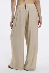 Pantalón de tela color celeste con textura arrugada, corte amplio y cintura elastizada.