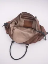 Bolso de viaje negro con detalles en cuero marrón, doble asa de mano y cierre superior con cremallera.
