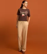 Remera alargada de algodón color marrón, con cuello redondo, mangas cortas y estampa frontal de un oso con sombrero de cowboy y la palabra "Howdy" escrita con una cuerda.