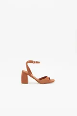 Sandalias de cuero gamuzado color marrón, con tira fina en el tobillo y tacón bloque bajo.