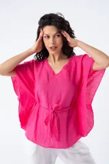 Blusa fucsia de viscosa, corte suelto, escote en V y mangas cortas tipo kimono. Incluye lazo del mismo material para ajustar a la cintura.