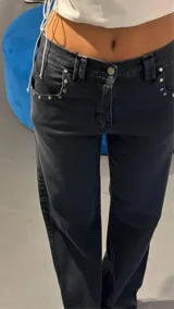 Pantalón de jean negro de corte recto y tiro medio.